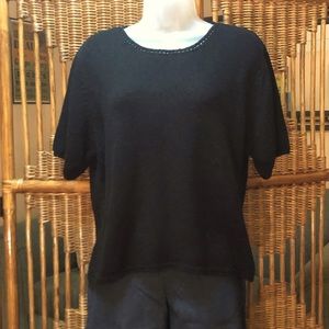 Short sleeved black knit top.
